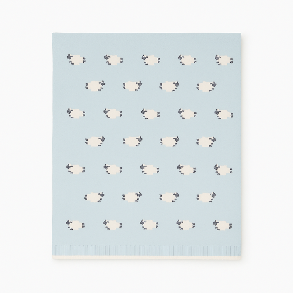 Patterned blanket with sheep design on a light blue background