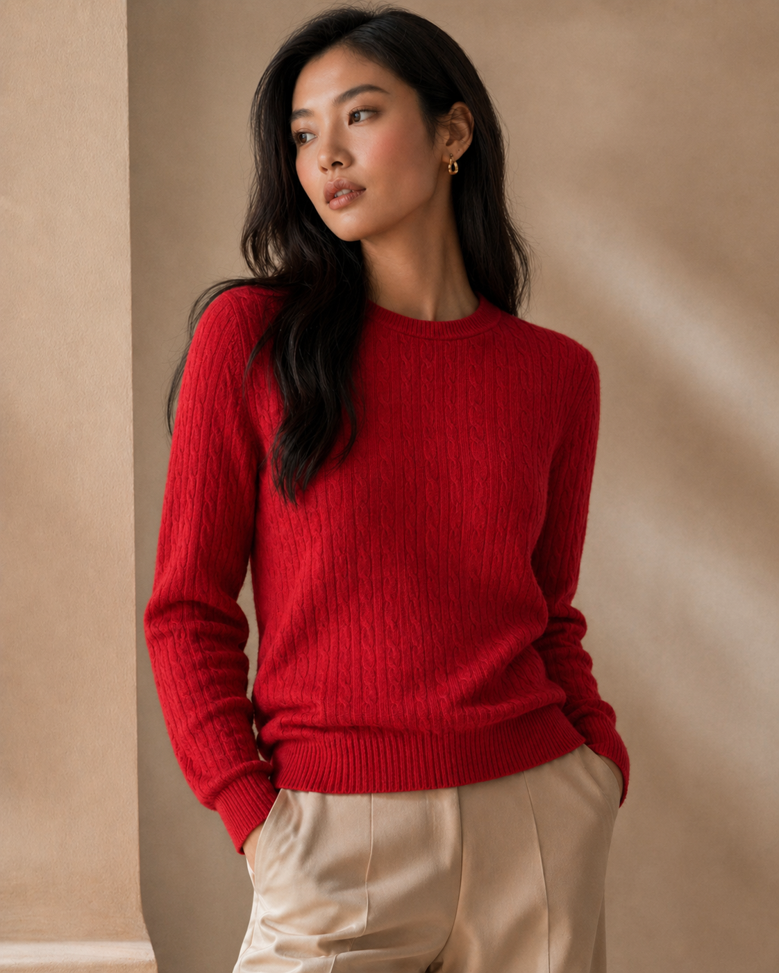 Woman wearing a red sweater against a beige background
